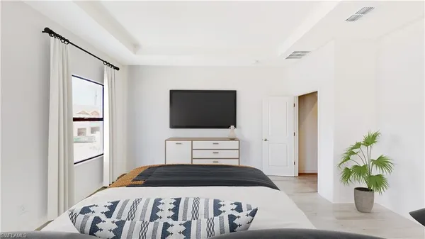 a bedroom with a bed and flat screen tv