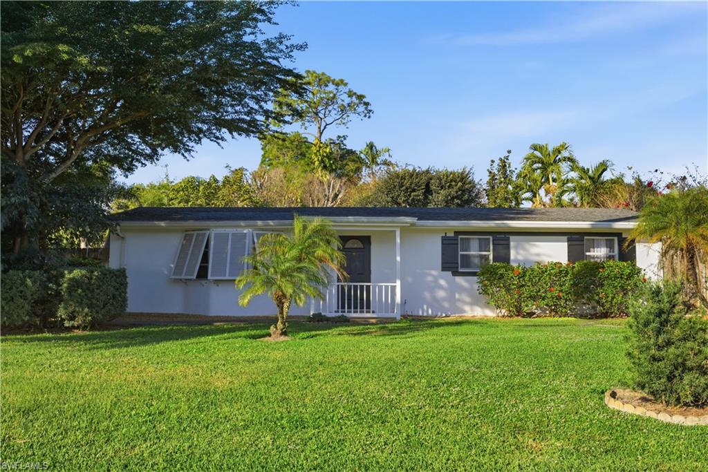 a front view of house with yard and outdoor seating