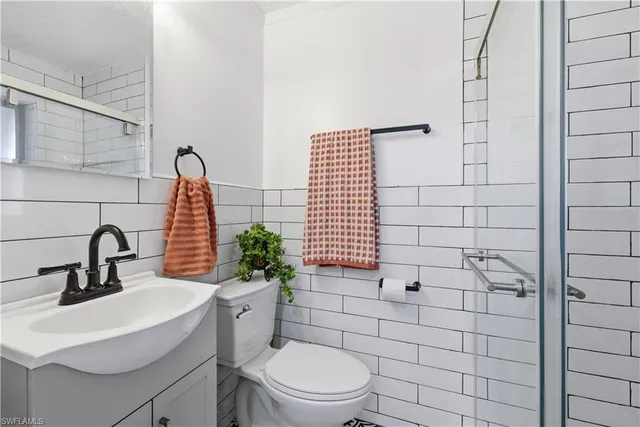 a bathroom with a sink toilet and shower