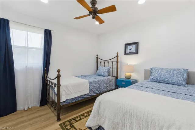 a bedroom with two beds and a window