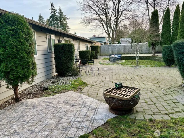 a view of a backyard with sitting area