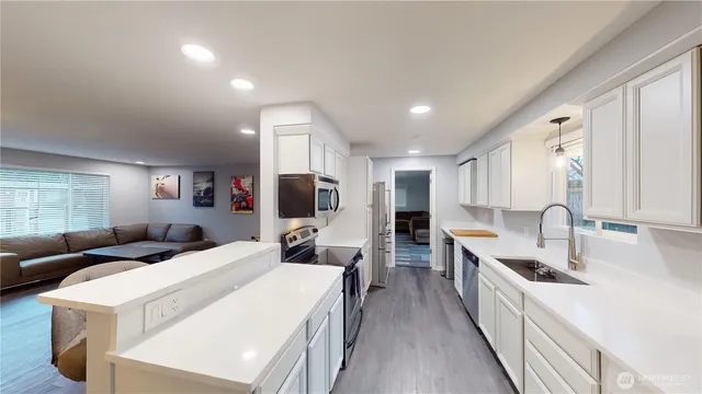 a large room with a large window and stainless steel appliances