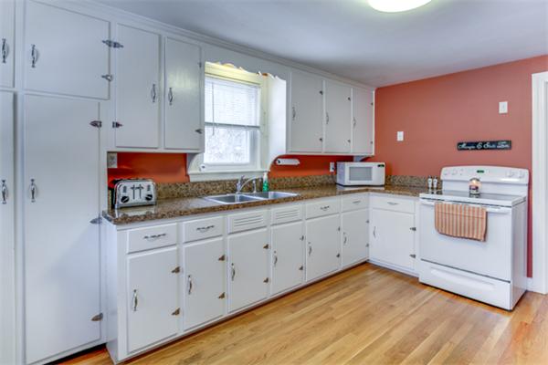 35 Woodland Road Wayland, MA 01778 - Photo 13 of 30 a kitchen with granite countertop white cabinets and white appliances