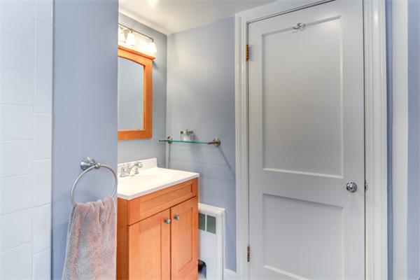 35 Woodland Road Wayland, MA 01778 - Photo 22 of 30 a bathroom with a sink a vanity and a mirror