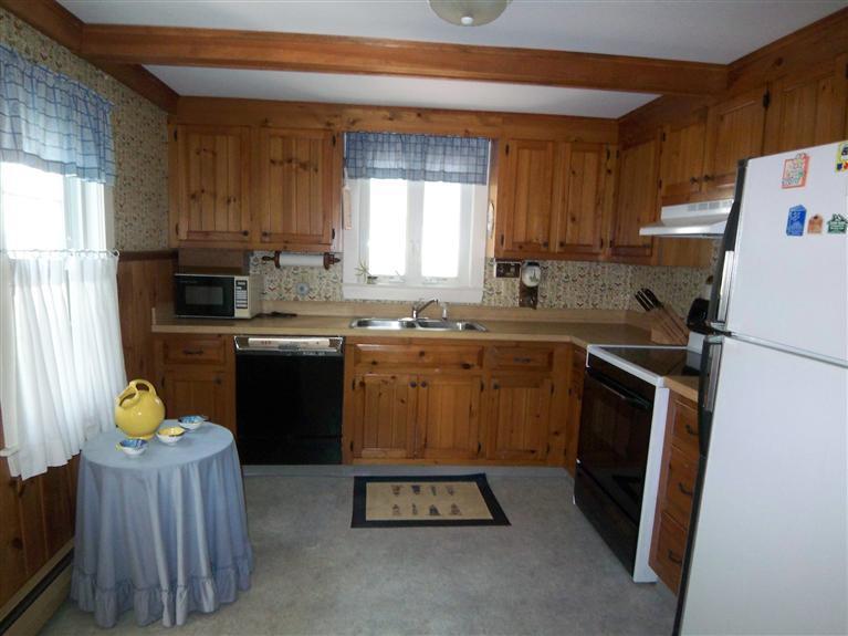 28 Manderville Road West Harwich, MA 02671 - Photo 2 of 18 a kitchen with a sink a stove cabinets and a window