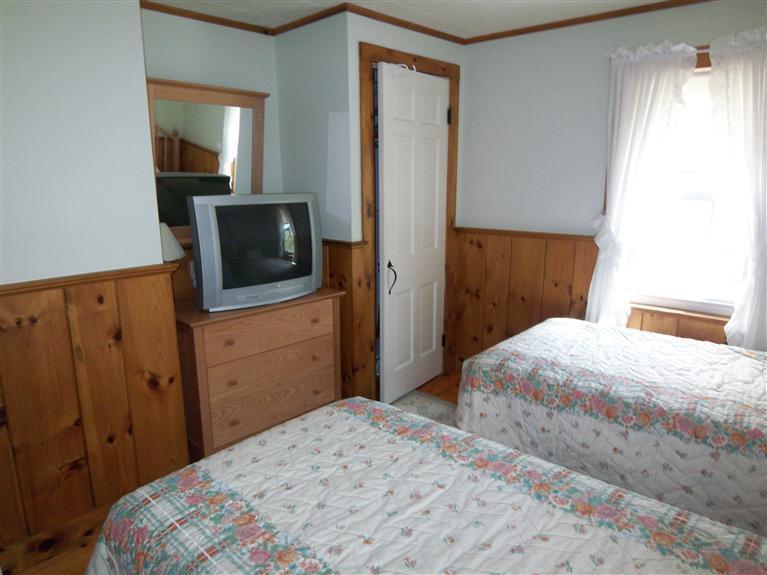 28 Manderville Road West Harwich, MA 02671 - Photo 7 of 18 a bedroom with a bed and a flat tv screen on dresser