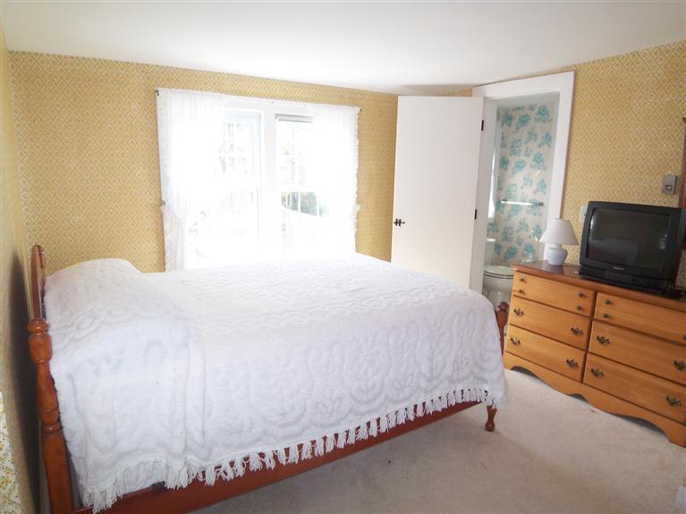 28 Manderville Road West Harwich, MA 02671 - Photo 9 of 18 a large bed sitting in a bedroom next to a window