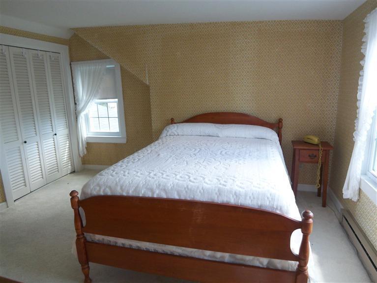 28 Manderville Road West Harwich, MA 02671 - Photo 10 of 18 a bed sitting in a bedroom next to a window