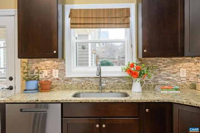 a kitchen with granite countertop a sink and a window
