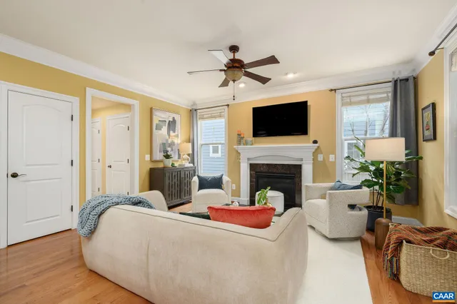 a living room with furniture a flat screen tv and a fireplace