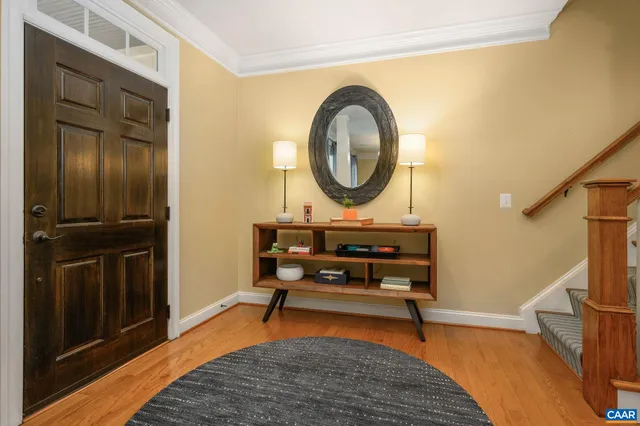 a living room with furniture a mirror and a sink