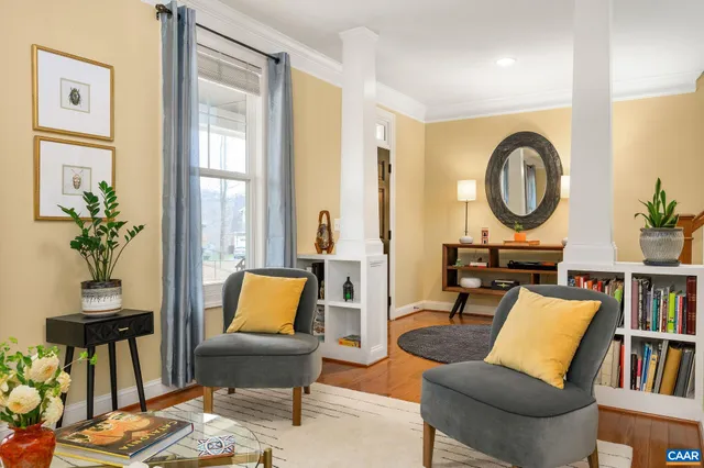 a living room with furniture and a book shelf