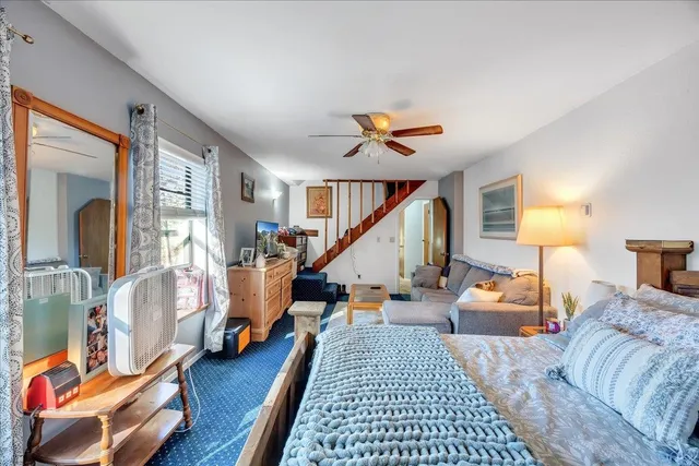 a bedroom with furniture and a wooden floor