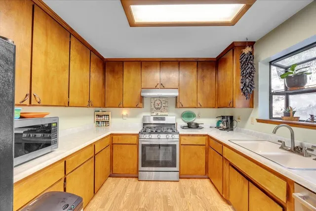 a kitchen with a sink stove and cabinets