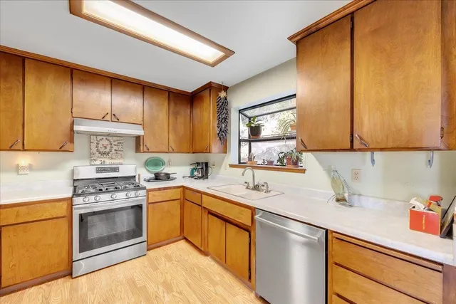 a kitchen with cabinets a sink and appliances