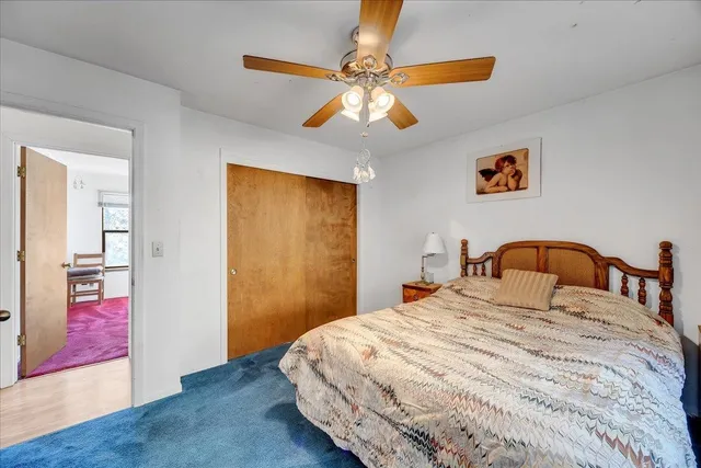 a bedroom with a large bed and a chandelier