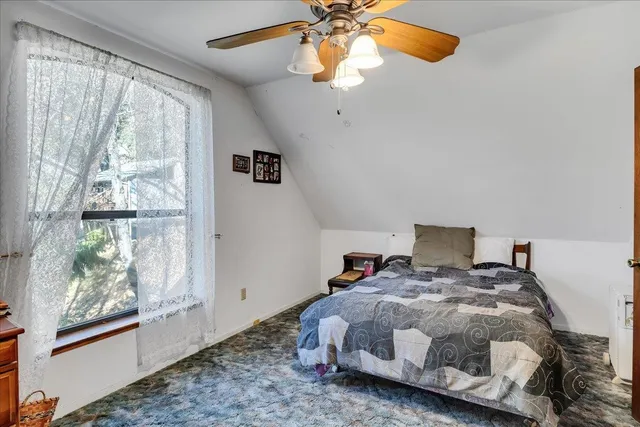 a bedroom with a bed and window