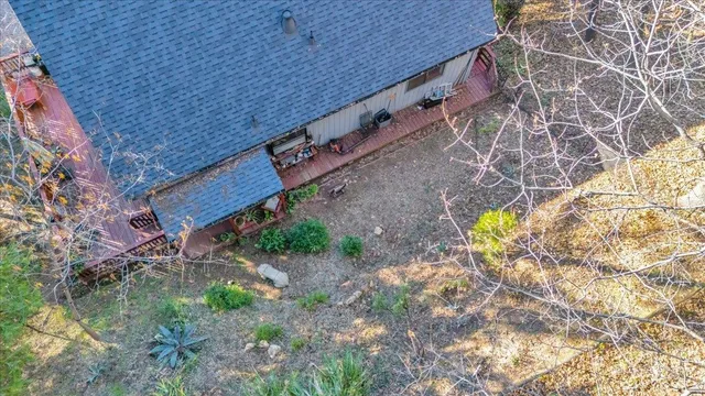 a view of a backyard with plants and wooden fence