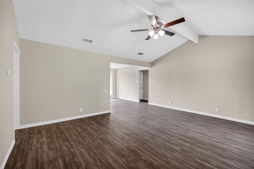 7528 Meadowlark Lane North Watauga, TX 76148 - Photo 5 of 31 an empty room with wooden floor and ceiling fan