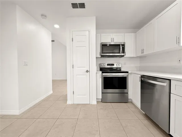a kitchen with a stove and a microwave