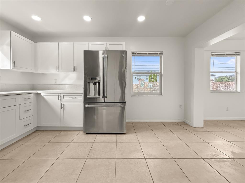 1610 Harbor Way Bartow, FL 33830 - Photo 18 of 25 a kitchen with white cabinets a sink a stove a refrigerator and a window