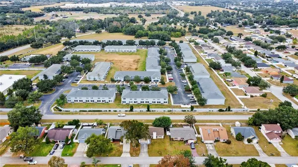 an aerial view of residential houses with outdoor space