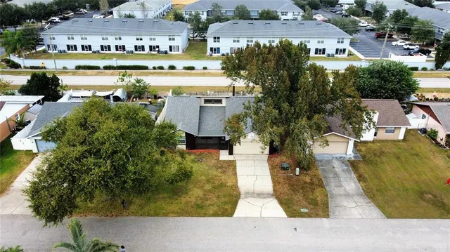 a aerial view of a house with swimming pool and outdoor seating