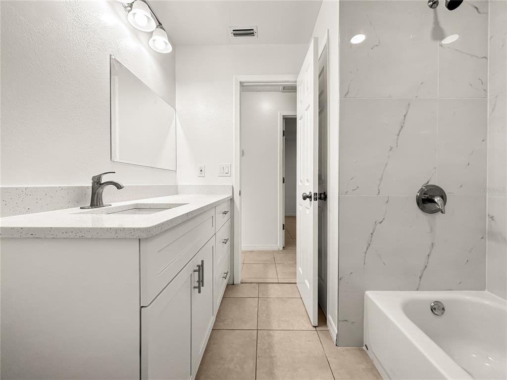 1610 Harbor Way Bartow, FL 33830 - Photo 9 of 25 a bathroom with a tub sink and mirror