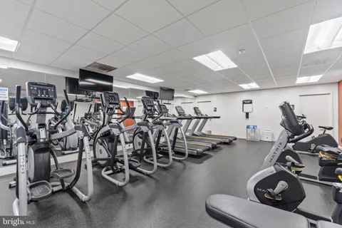 a living room with furniture and a lamp