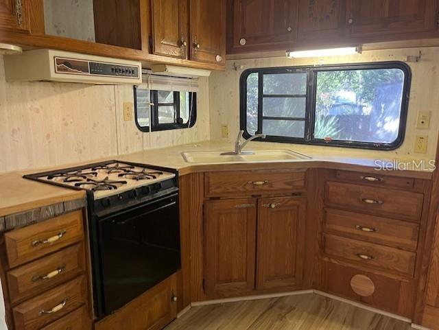3000 Clarcona Road, Unit 445 Apopka, FL 32703 - Photo 13 of 13 a kitchen with stainless steel appliances granite countertop a stove a sink and a microwave