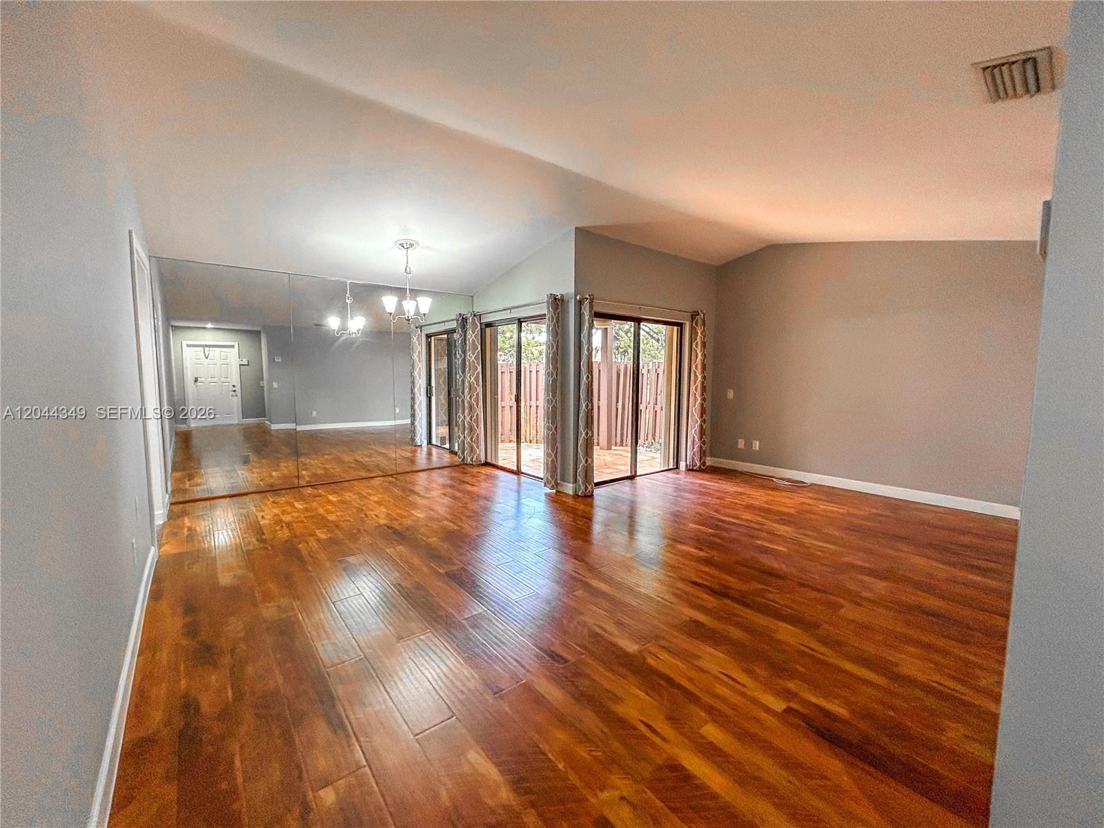 14970 Southwest 48th Terrace, Unit 27G Miami, FL 33185 - Photo 2 of 14 a view of an empty room and wooden floor