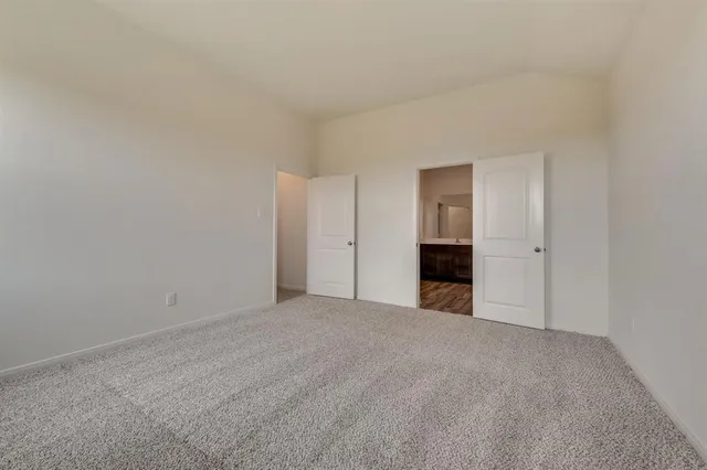 a view of an empty room with a fireplace and a window