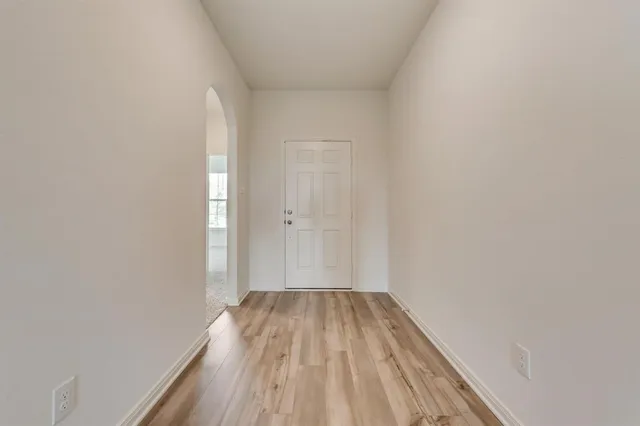 a view of a room with wooden floor and bench