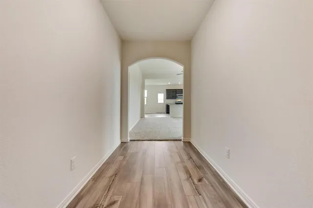 a view of a room with wooden floor and a bathroom