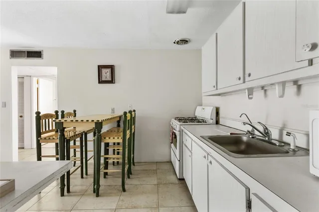 a spacious bedroom with a bed and a cabinets