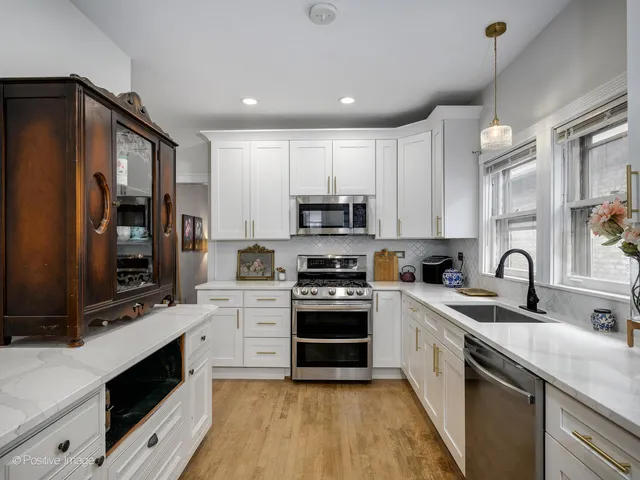 a kitchen with stainless steel appliances granite countertop a sink and cabinets