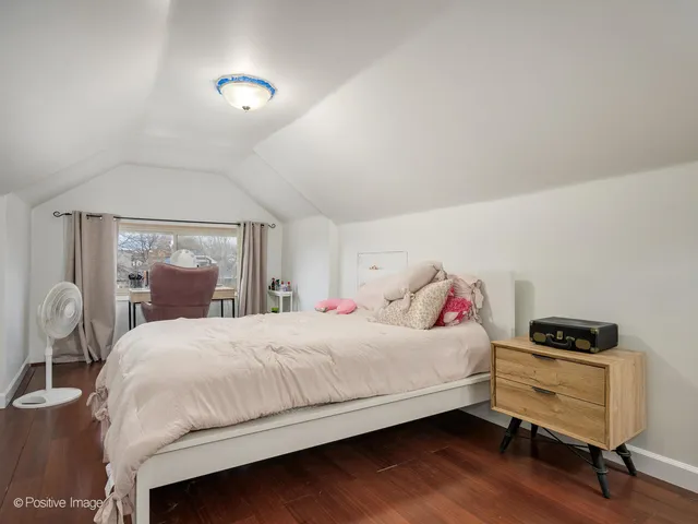 a bedroom with a bed and a table in it