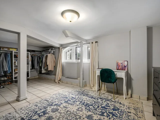 a view of a hallway to a livingroom with furniture and a couch