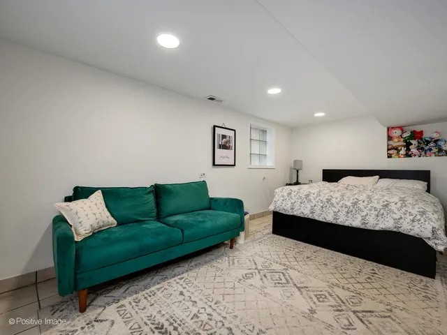 a bedroom with a bed and a couch