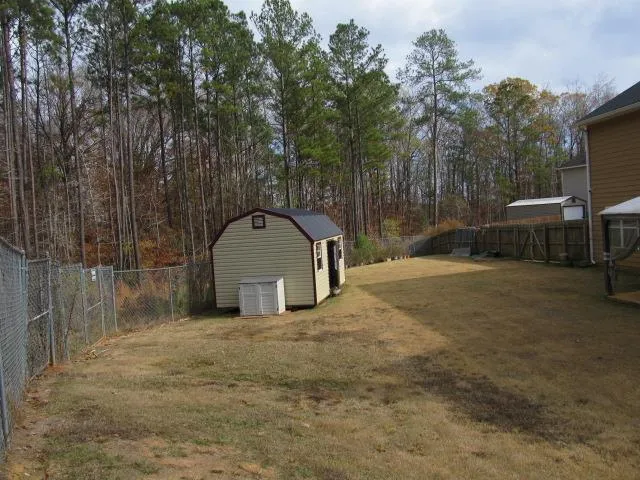 a view of a house with a yard and garage