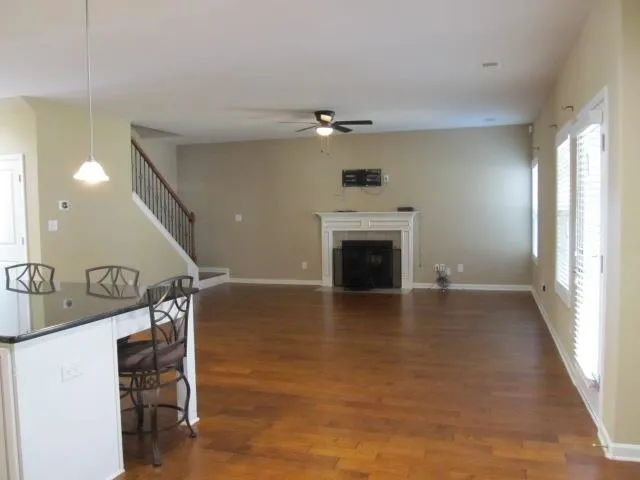 a view of an empty room with a fireplace and a window
