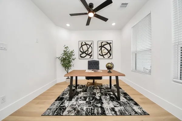a living room with a table and a rug
