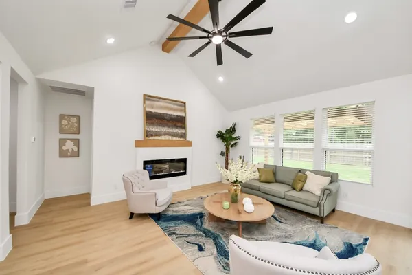 a living room with furniture and a wooden floor