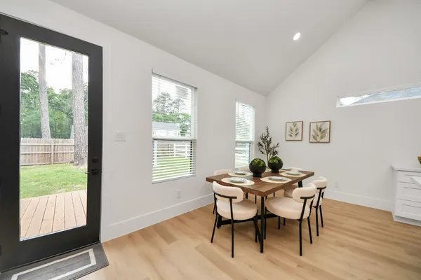 a dining room with furniture a rug and wooden floor