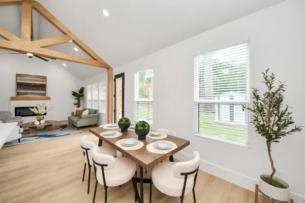 a view of a dining room with furniture window and wooden floor