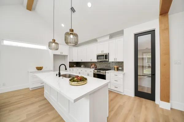 a kitchen with a sink a stove and refrigerator