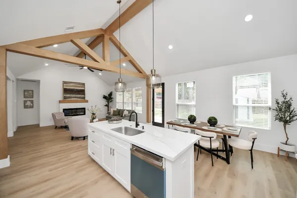 a large white kitchen with a large window