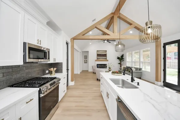 a kitchen with a sink stove and microwave