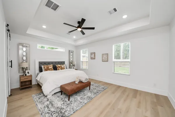 a bedroom with a large bed and a window