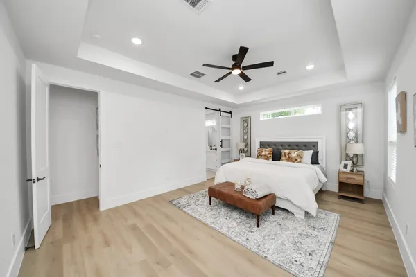 a bed room with a bed and a chandelier
